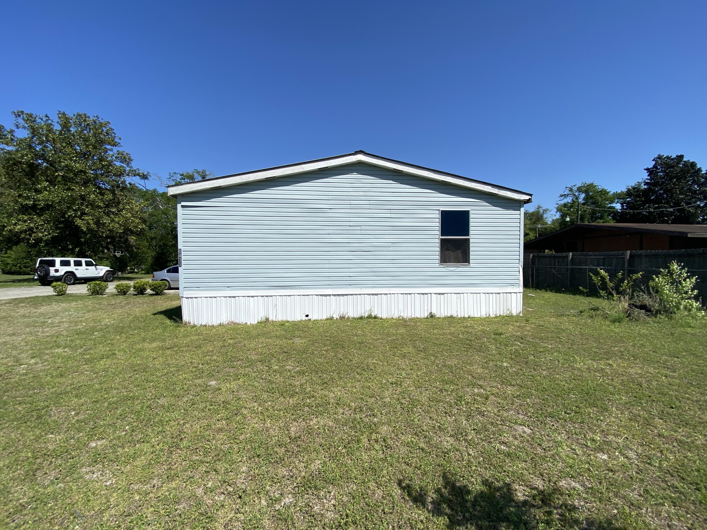 6427 Firestone Road Jacksonville, FL 32244 - Photo 32 of 55 a view of a house with a yard