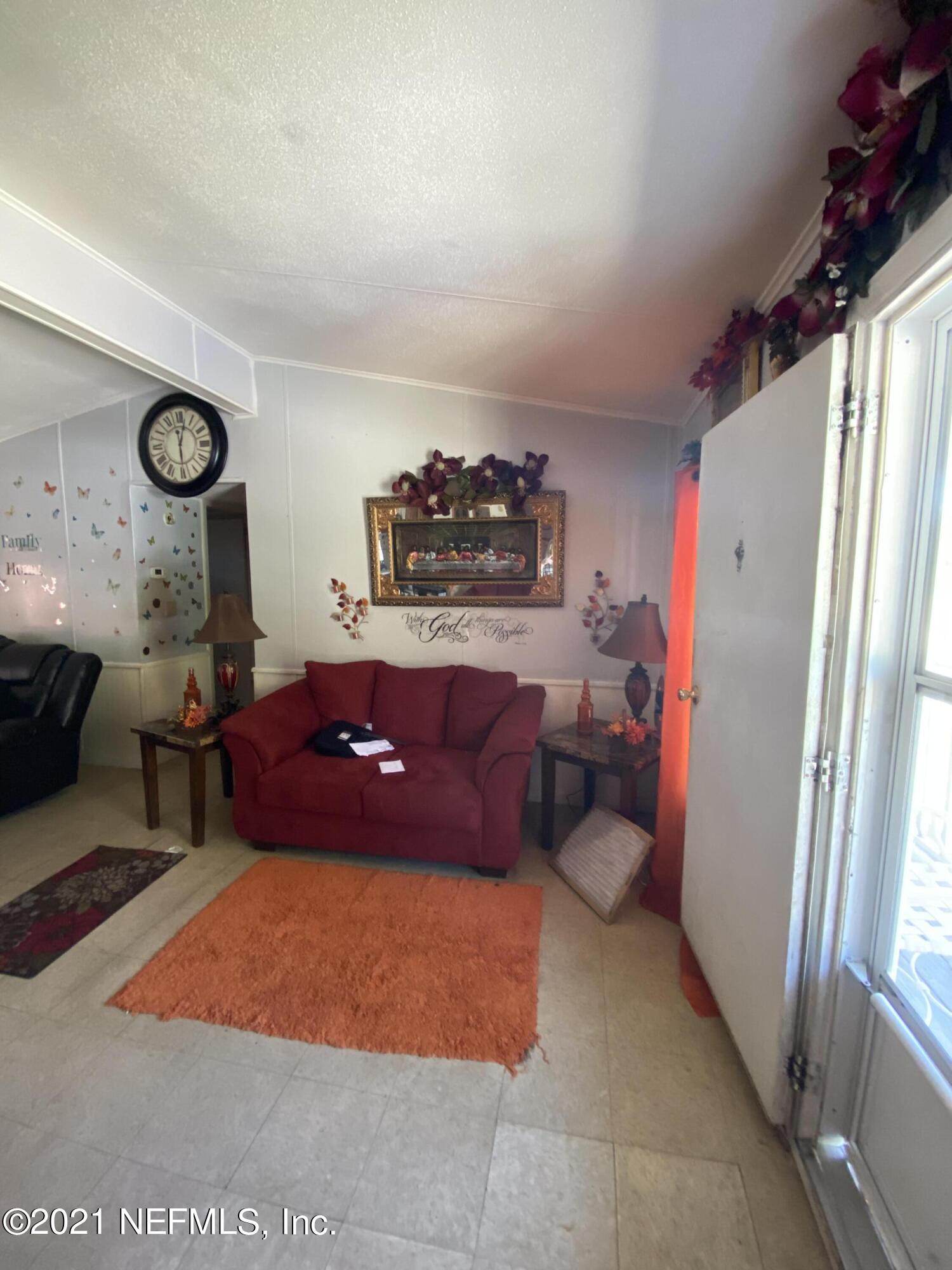 6427 Firestone Road Jacksonville, FL 32244 - Photo 34 of 55 a living room with furniture and a large window
