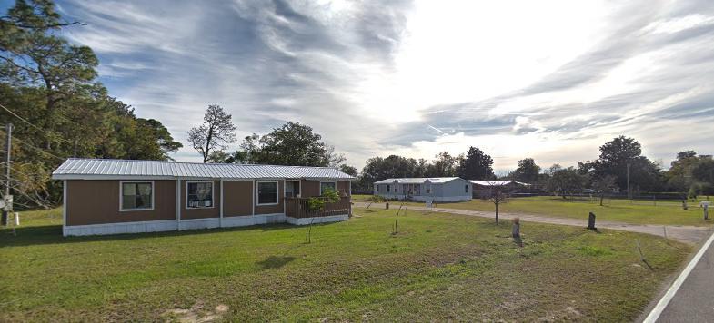 6427 Firestone Road Jacksonville, FL 32244 - Photo 4 of 55 a view of a house with backyard porch and sitting area
