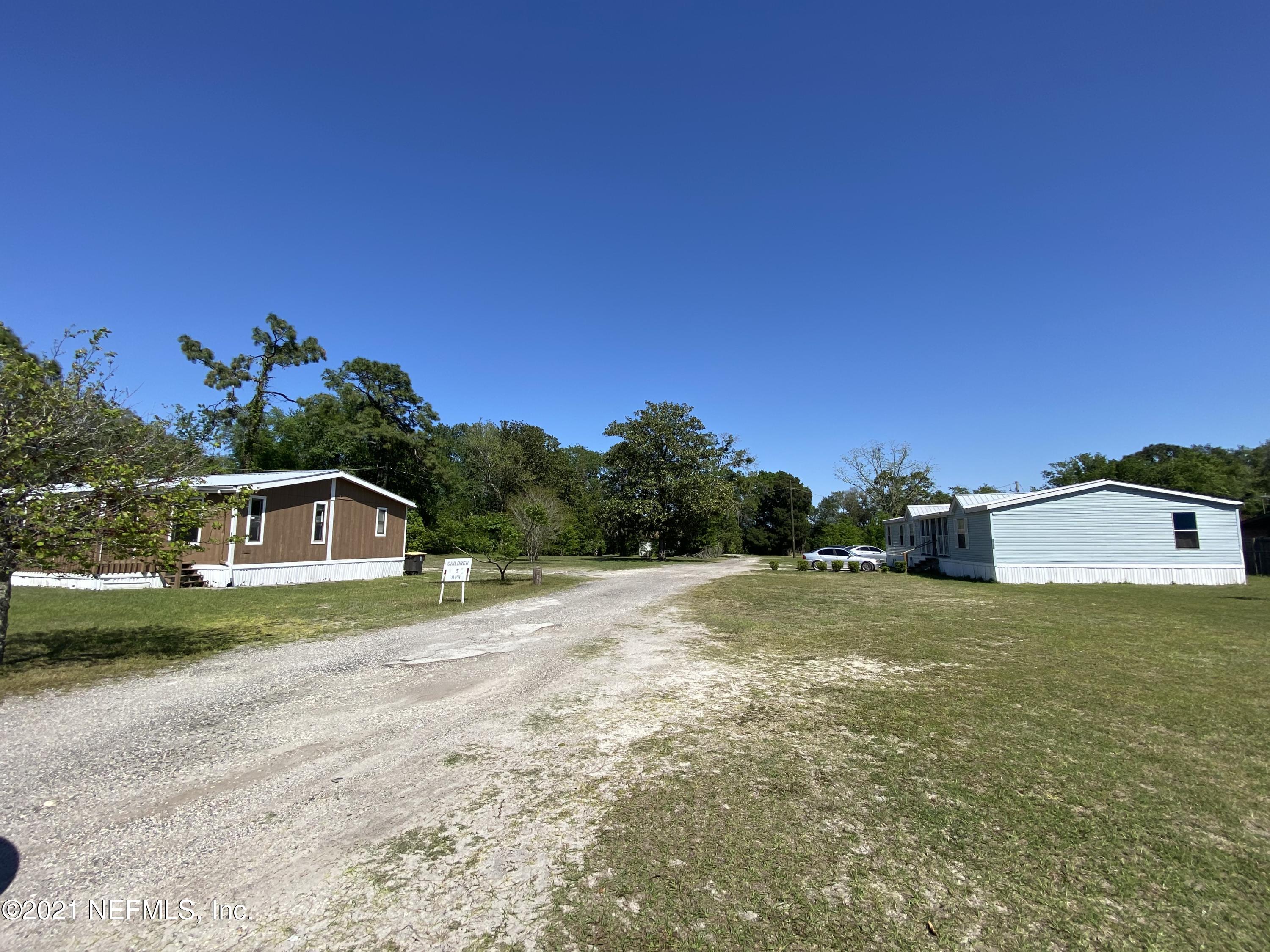 6427 Firestone Road Jacksonville, FL 32244 - Photo 43 of 55 a front view of a house with a yard and garage