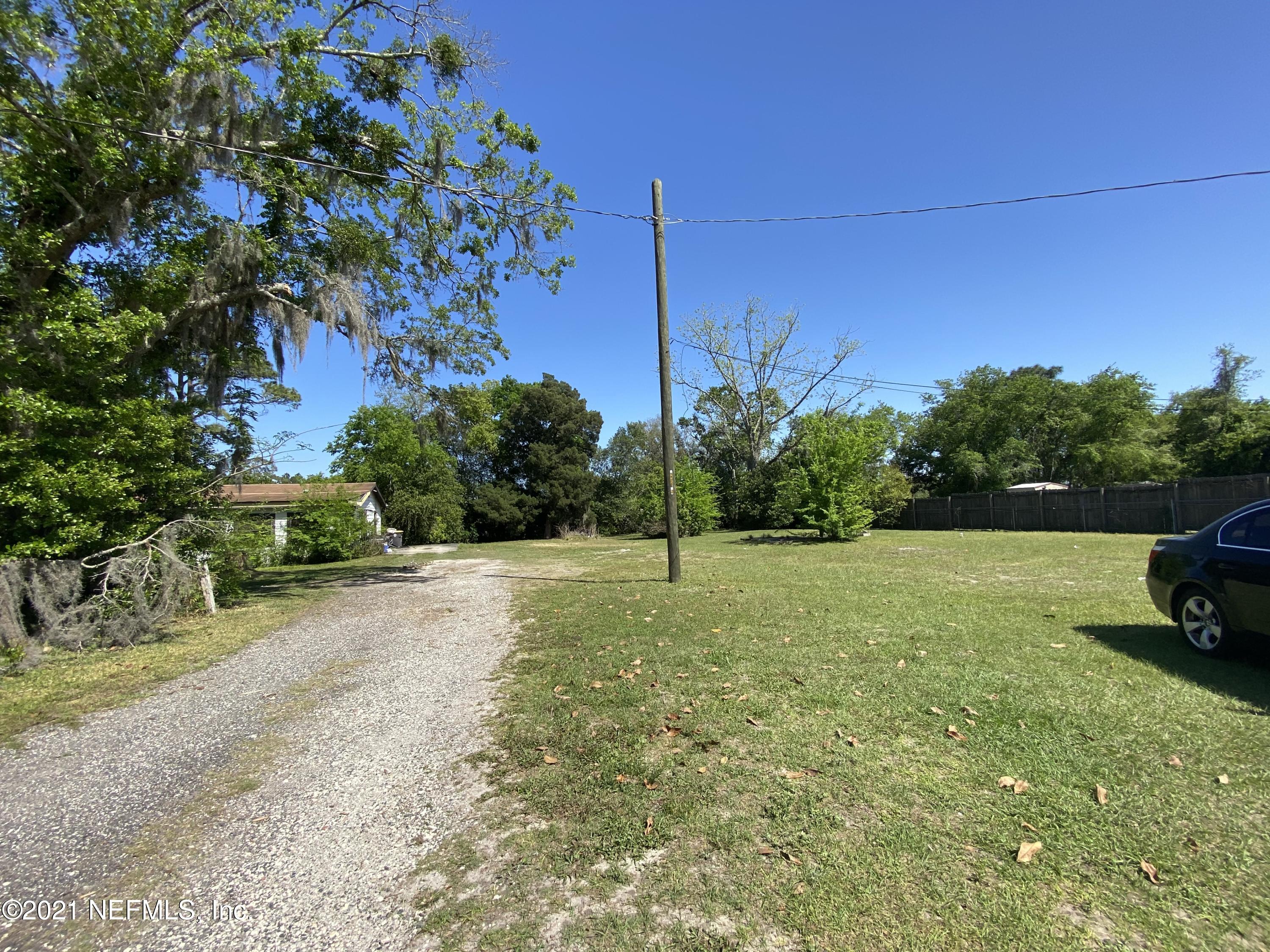 6427 Firestone Road Jacksonville, FL 32244 - Photo 44 of 55 a view of a yard with a house in the background