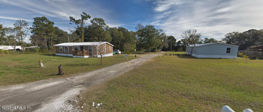 6427 Firestone Road Jacksonville, FL 32244 - Photo 5 of 55 a view of a house with a yard and garage