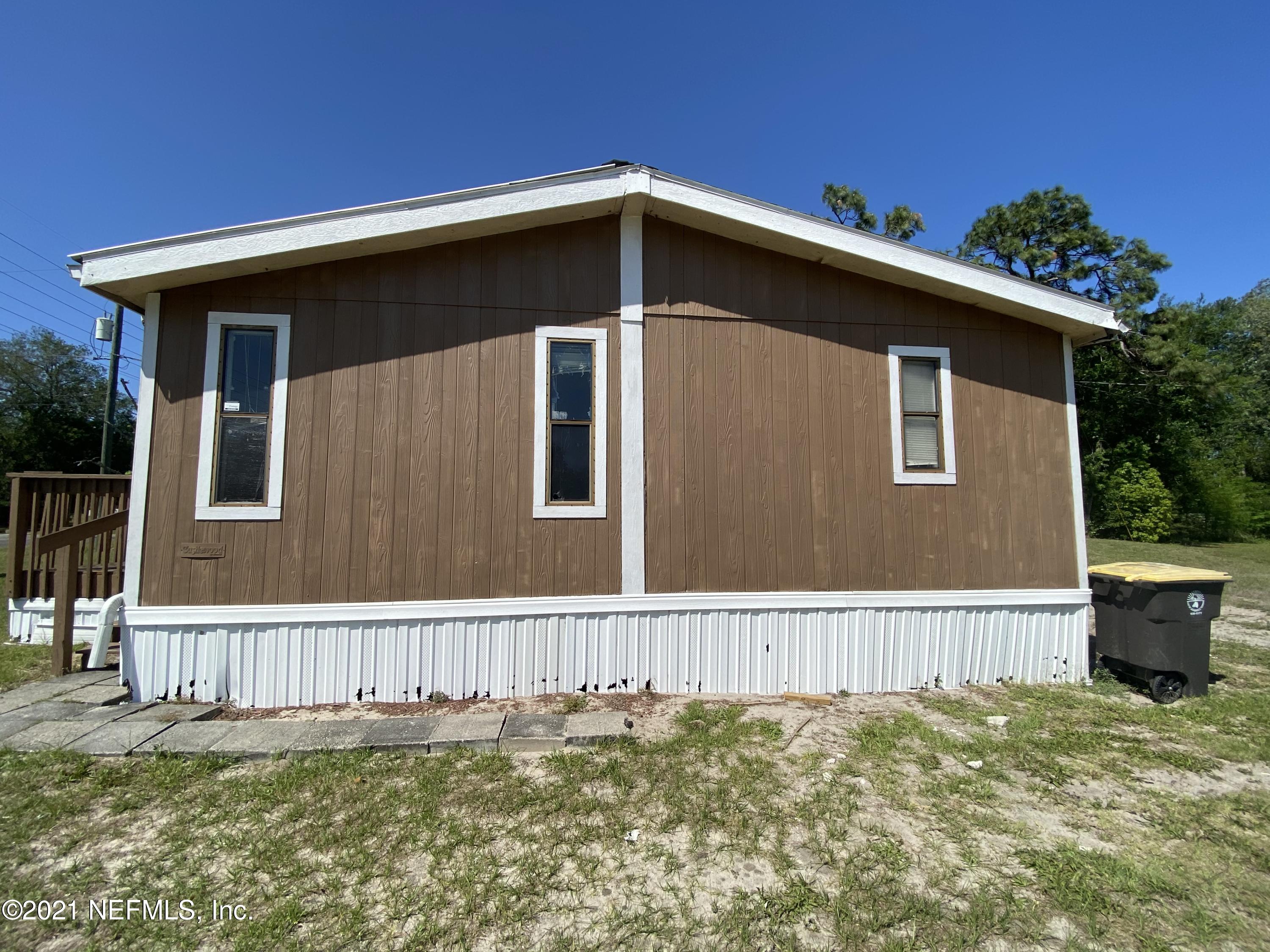 6427 Firestone Road Jacksonville, FL 32244 - Photo 8 of 55 a front view of a house with a yard