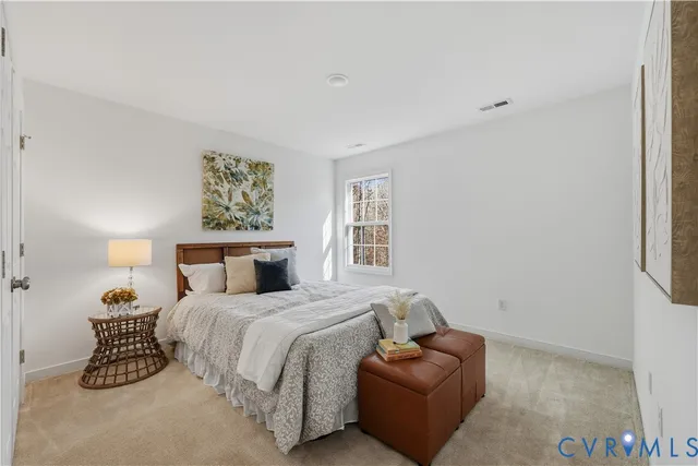 a bedroom with a bed and a couch