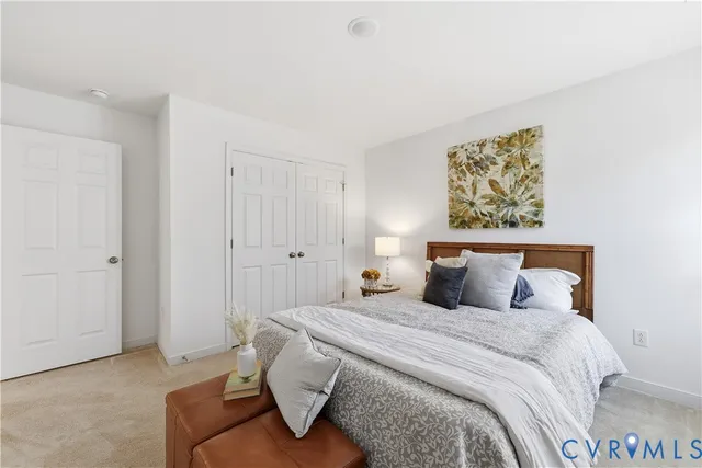 a bedroom with a bed and painting on the wall