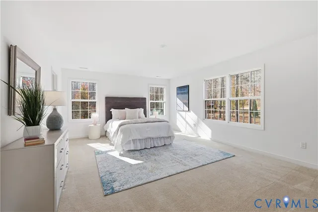 a bedroom with a large bed and a window