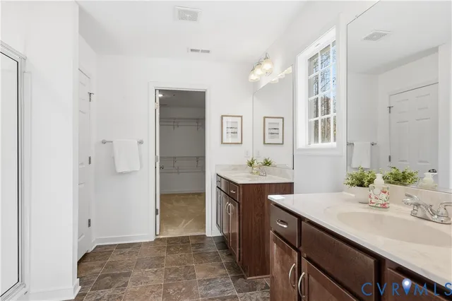 a bathroom with a granite countertop sink a toilet and shower