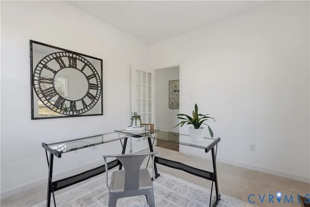 a bench sitting in a room next to a window with potted plants