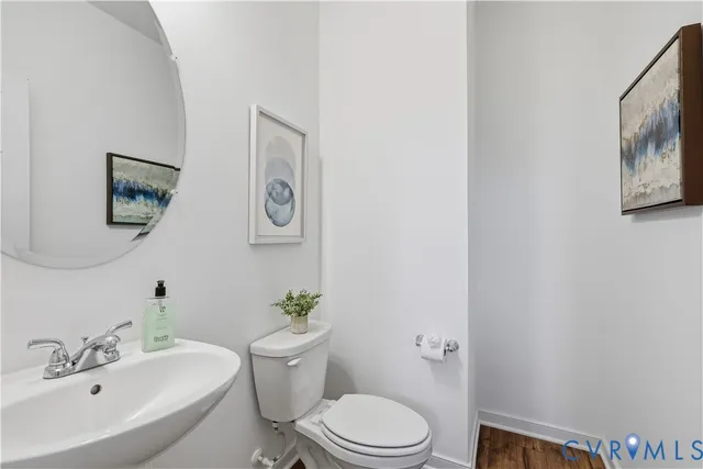 a white toilet sitting next to a bathroom sink