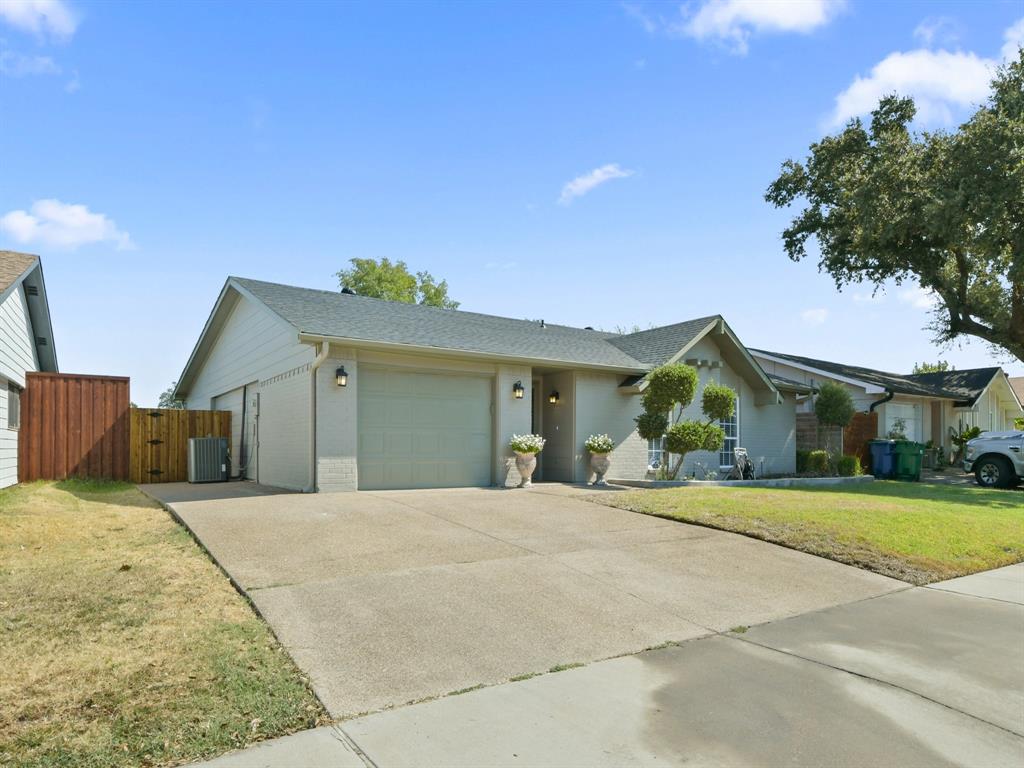2033 Lymington Road Carrollton, TX 75007 - Photo 2 of 33 Single-story residence featuring an attached garage, concrete driveway, and a wood privacy fence