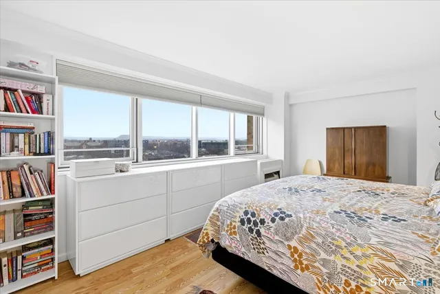 a bedroom with bed and a window