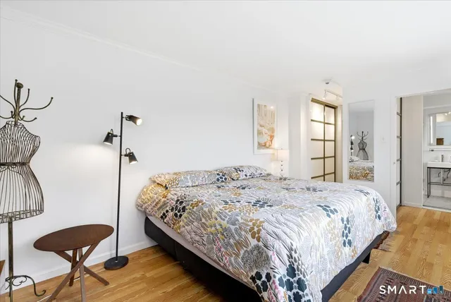 a bedroom with a bed and a large window