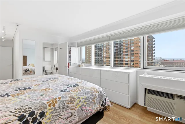 a bathroom with a sink toilet a mirror and shower