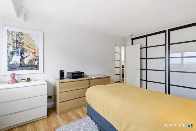 a view of a balcony with wooden floor and fence