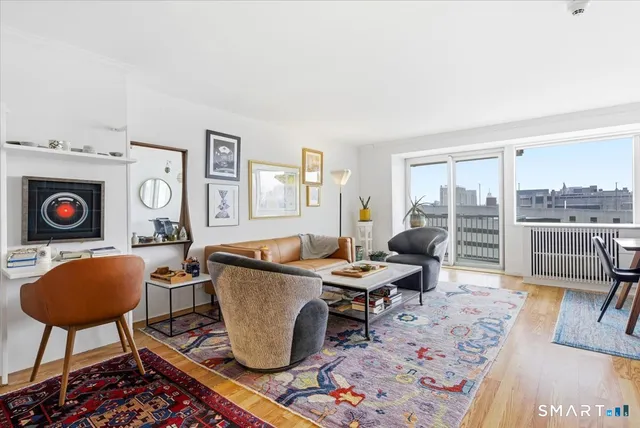 a living room with furniture a rug and a table