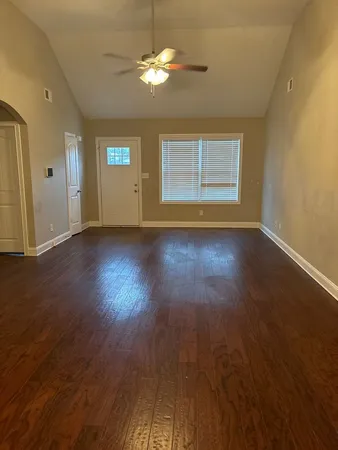 a view of room with window and hardwood floor