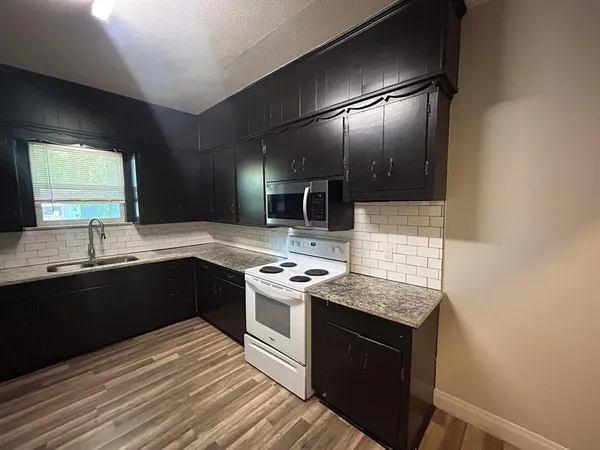 a kitchen with stainless steel appliances granite countertop a stove and a sink