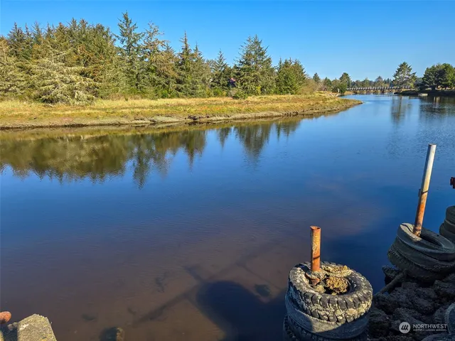 a view of a lake with an outdoor space and seating