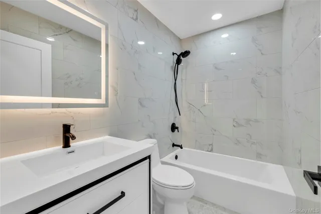 a bathroom with a sink a toilet and a shower