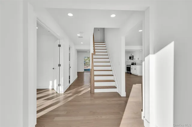 a view of entryway with white walls and stairs