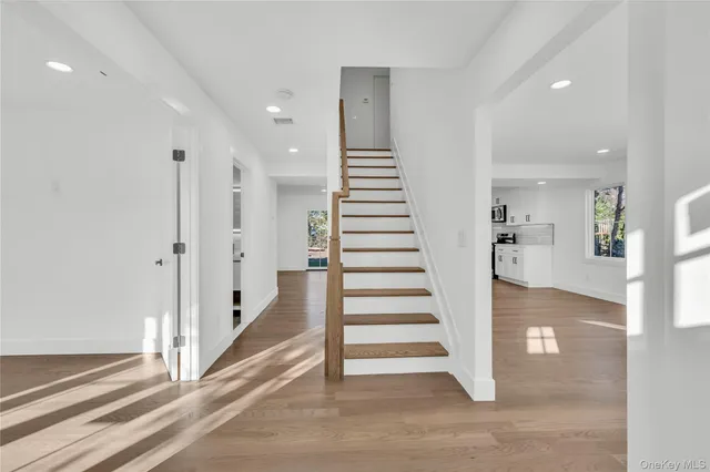 a view of entryway with white walls and stairs