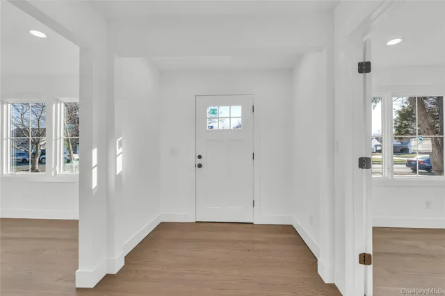 an empty room with windows and entrance