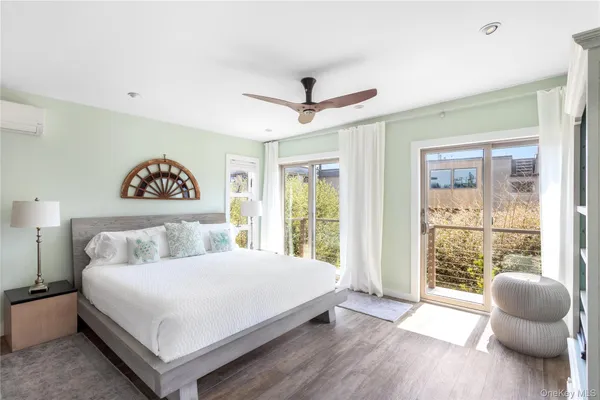 a bedroom with a bed and a painting on the wall