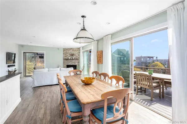 a dining room with furniture a chandelier and wooden floor