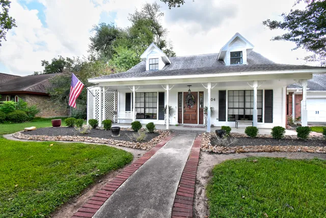 a front view of a house with swimming pool and porch