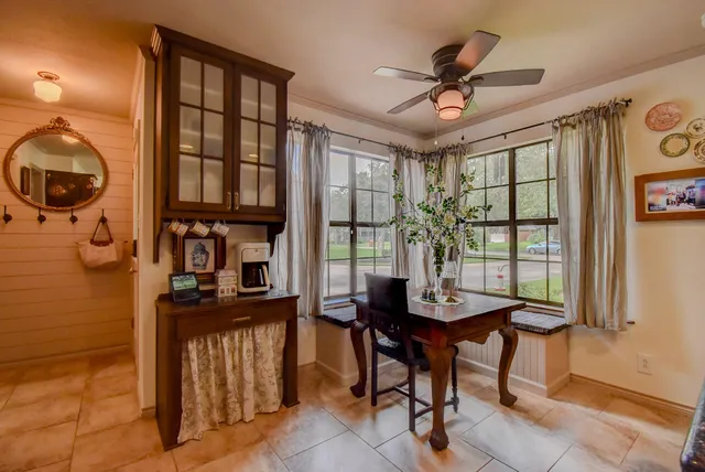a view of a dining room with furniture and a window