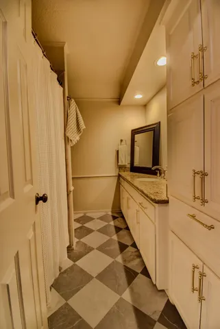 a bathroom with a sink a mirror and a shower