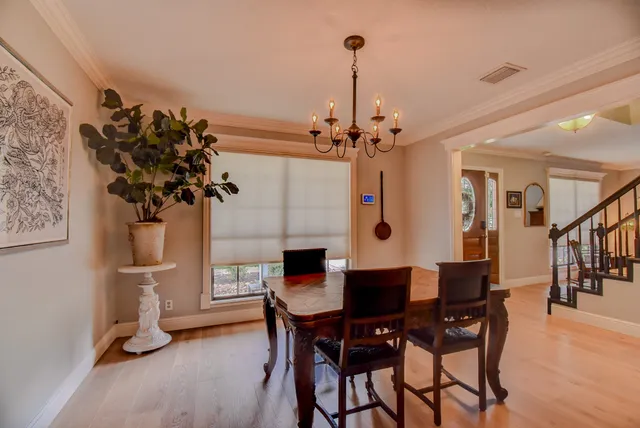a view of a dining room with furniture and a chandelier
