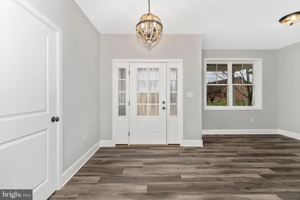 a view of an entryway with wooden floor