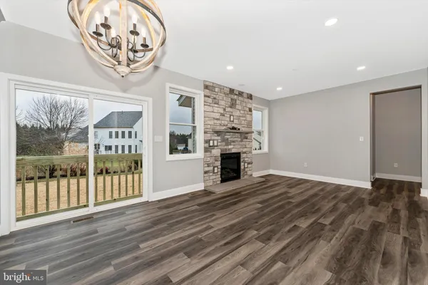 a view of an empty room with a fireplace and a window