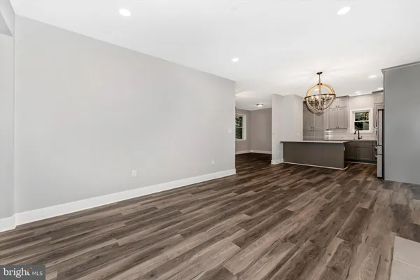 a view of a room with wooden floor window and a kitchen space