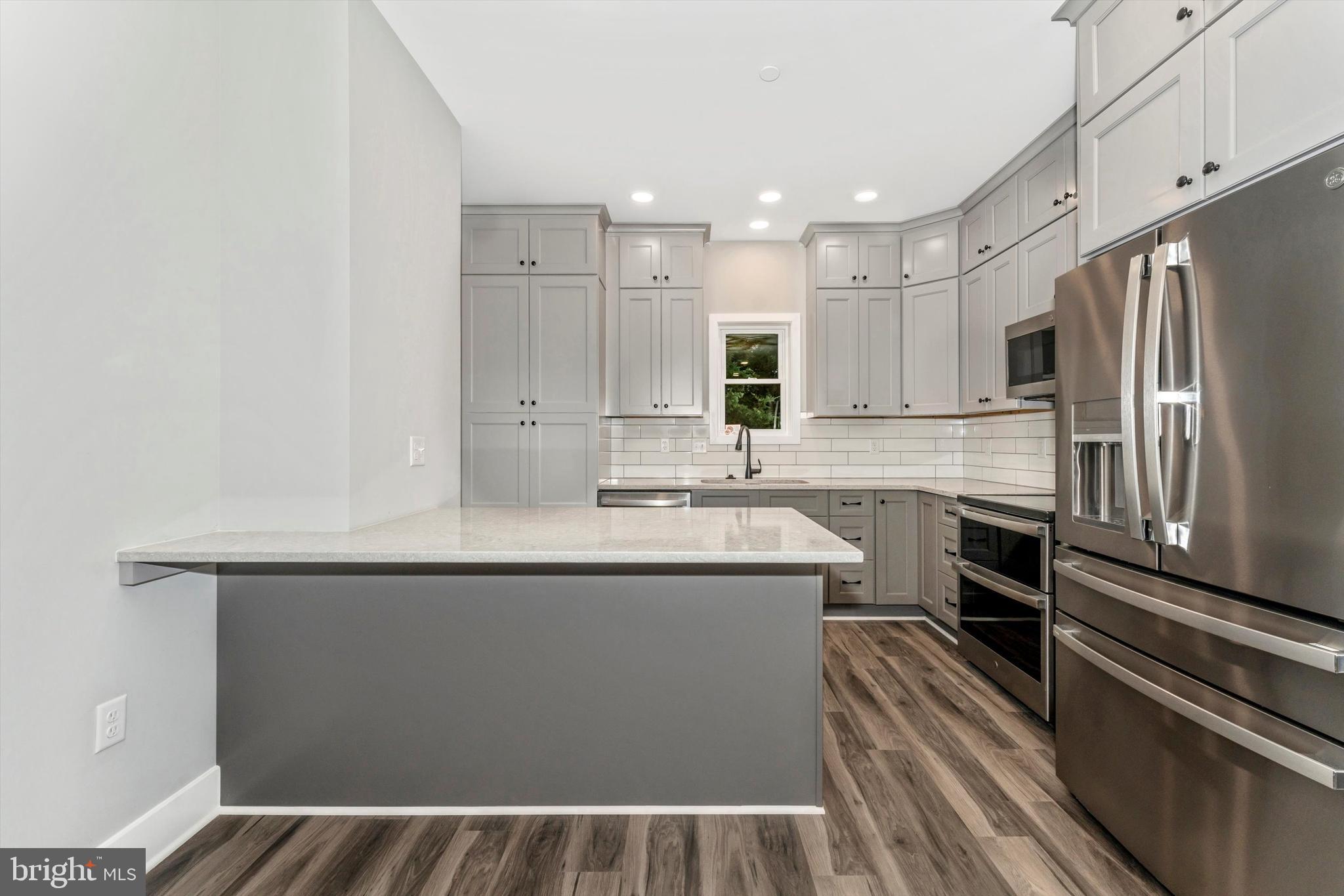 7792 Fairplay Road Fairplay, MD 21733 - Photo 20 of 45 a kitchen with kitchen island a sink stainless steel appliances and cabinets