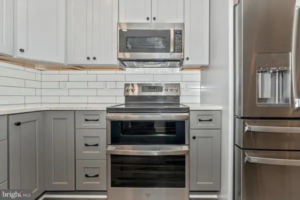 a kitchen with cabinets and stainless steel appliances