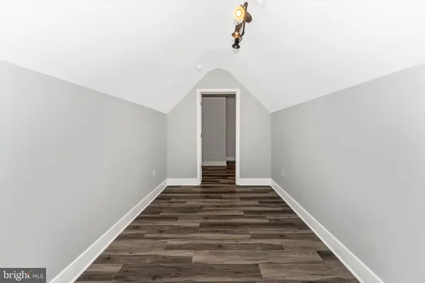 a view of a livingroom with wooden floor and stairs