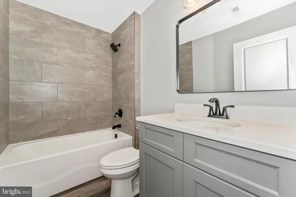 a bathroom with a sink a toilet and a bathtub