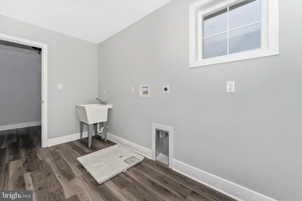 a view of a room with a wooden floor and a window