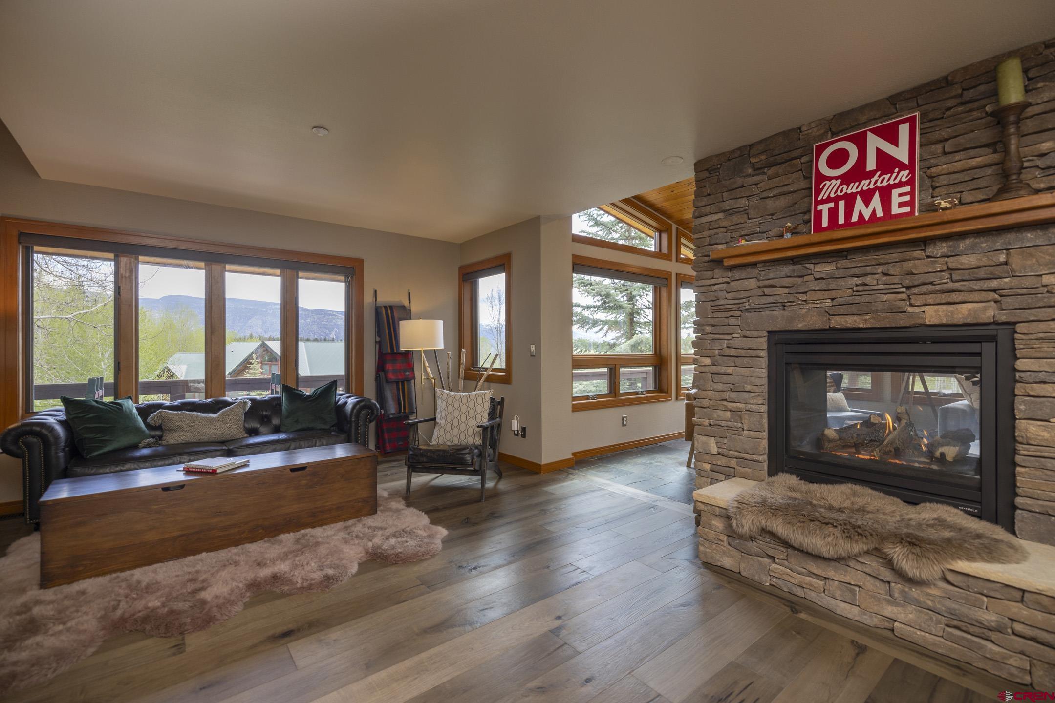 154 Falcon Ridge Road Durango, CO 81301 - Photo 11 of 42 a living room with furniture large window and a fireplace