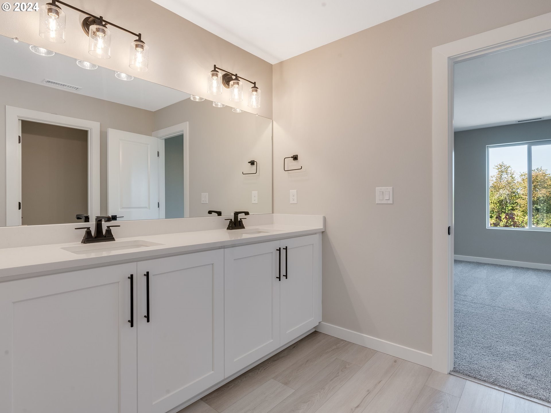 850 Northwest 178th Street Ridgefield, WA 98642 - Photo 38 of 48 a bathroom with double vanity sink and a mirror