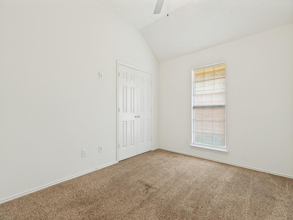 7641 King Arthur Road Frisco, TX 75035 - Photo 10 of 16 Bright bedroom featuring neutral wall finishes, carpet flooring, a large window with natural light, and a double-door closet with six-panel doors
