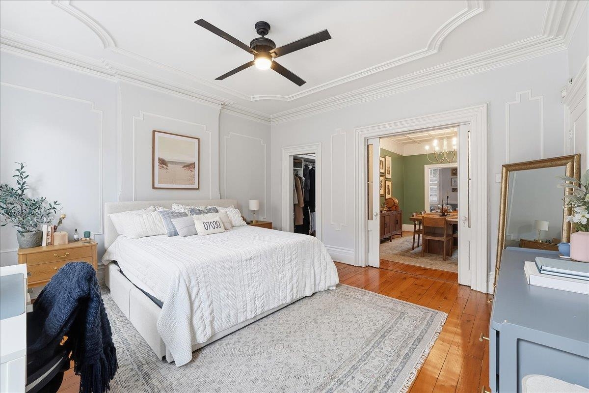 826 Washington Street, Unit 2 Hoboken, NJ 07030 - Photo 17 of 42 a bedroom with a large bed and a chandelier