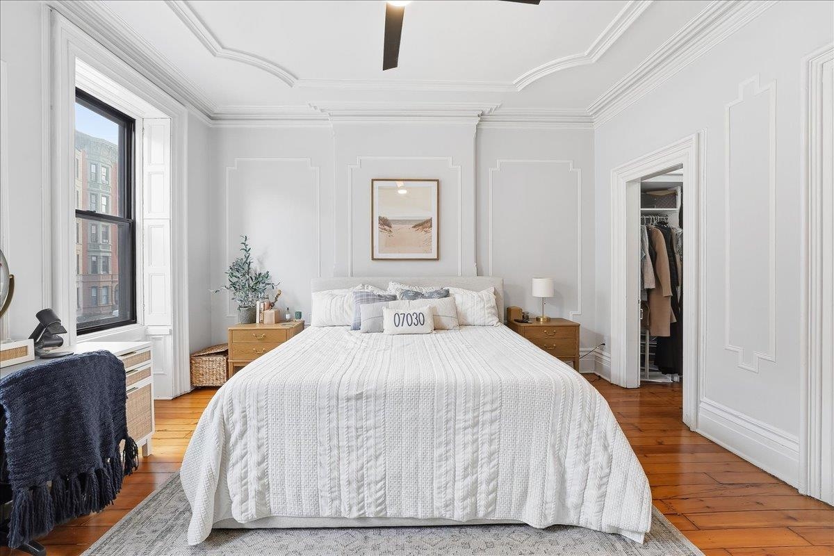 826 Washington Street, Unit 2 Hoboken, NJ 07030 - Photo 18 of 42 a bedroom with a large bed and a chandelier