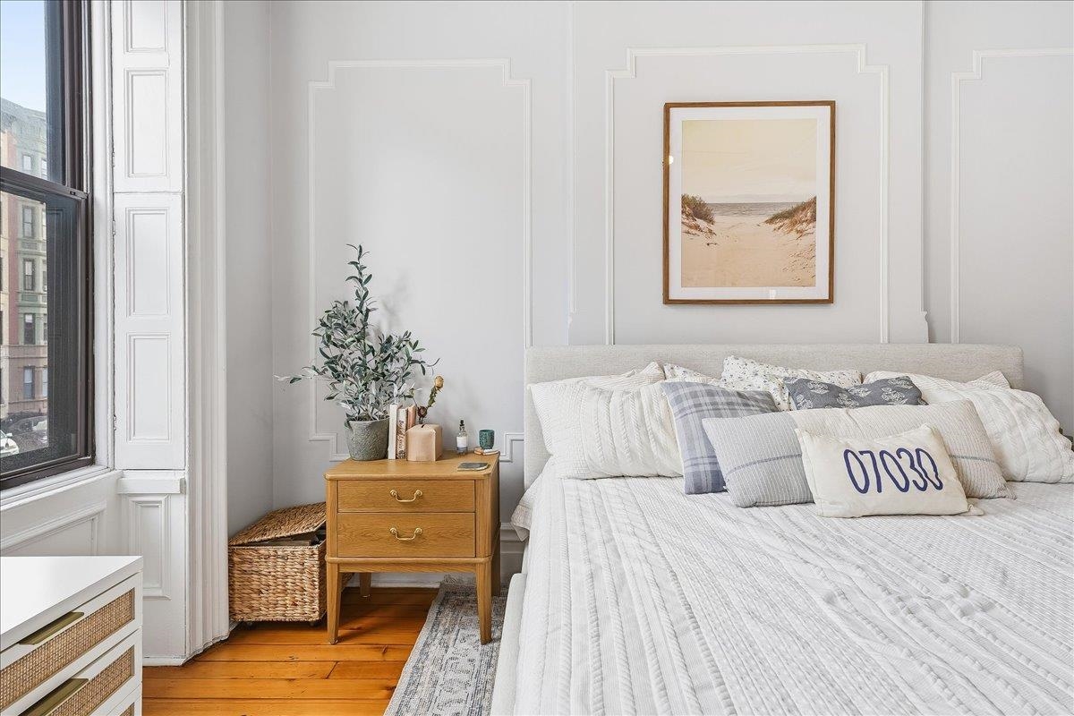 826 Washington Street, Unit 2 Hoboken, NJ 07030 - Photo 19 of 42 a bedroom with a bed and wooden floor