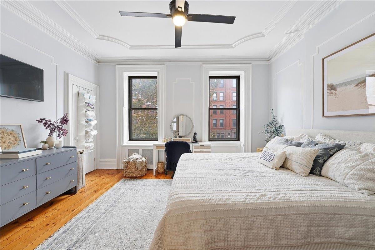 826 Washington Street, Unit 2 Hoboken, NJ 07030 - Photo 21 of 42 a bedroom with a large bed and flat tv screen on dresser