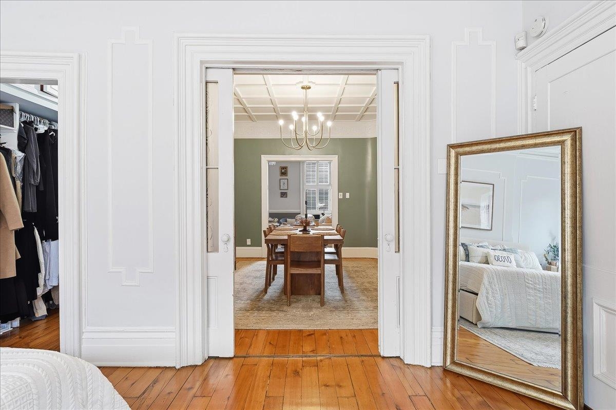 826 Washington Street, Unit 2 Hoboken, NJ 07030 - Photo 23 of 42 a view of a hallway with wooden floor a fireplace and a bathroom