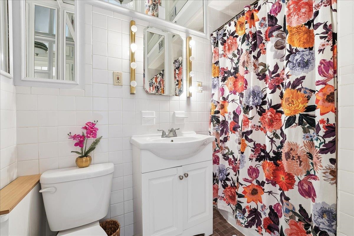 826 Washington Street, Unit 2 Hoboken, NJ 07030 - Photo 26 of 42 a bathroom with a sink toilet and shower