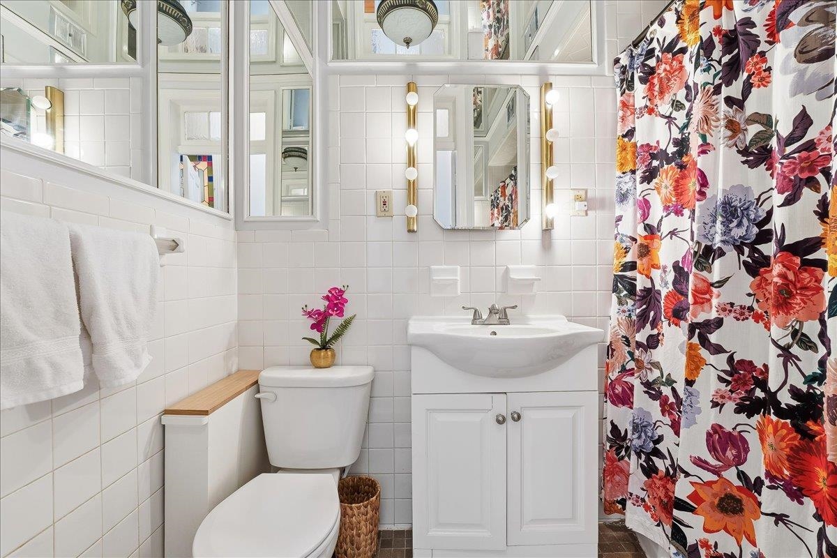 826 Washington Street, Unit 2 Hoboken, NJ 07030 - Photo 27 of 42 a bathroom with a sink toilet and a mirror